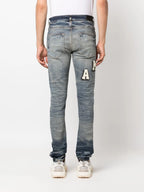 Amiri Blue Skinny-fit Logo-appliquéd Distressed Jeans
